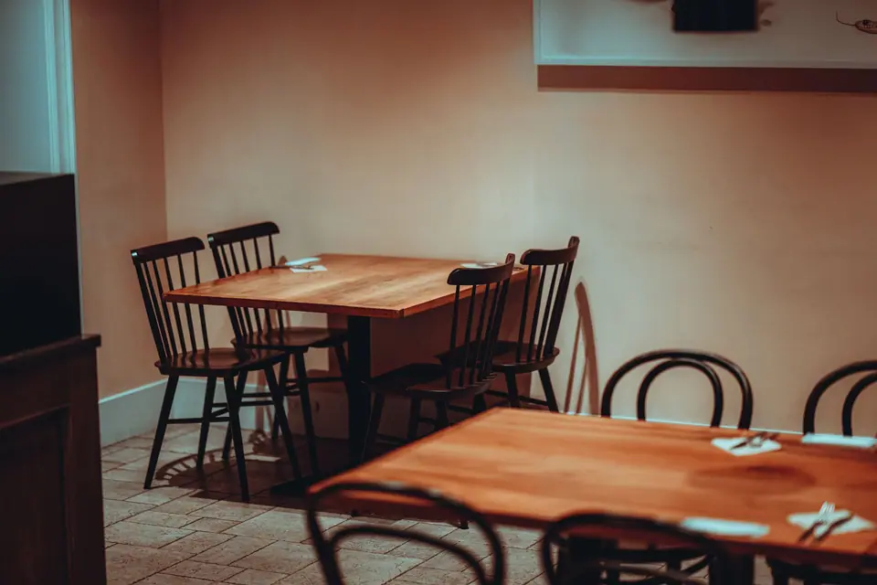 View of Empty Tables and Chairs in a Restaurant 