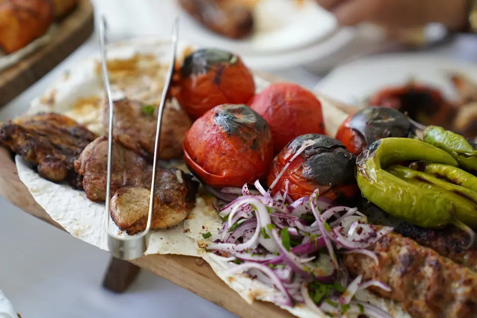 Delicious Grilled BBQ Platter with Peppers and Tomatoes